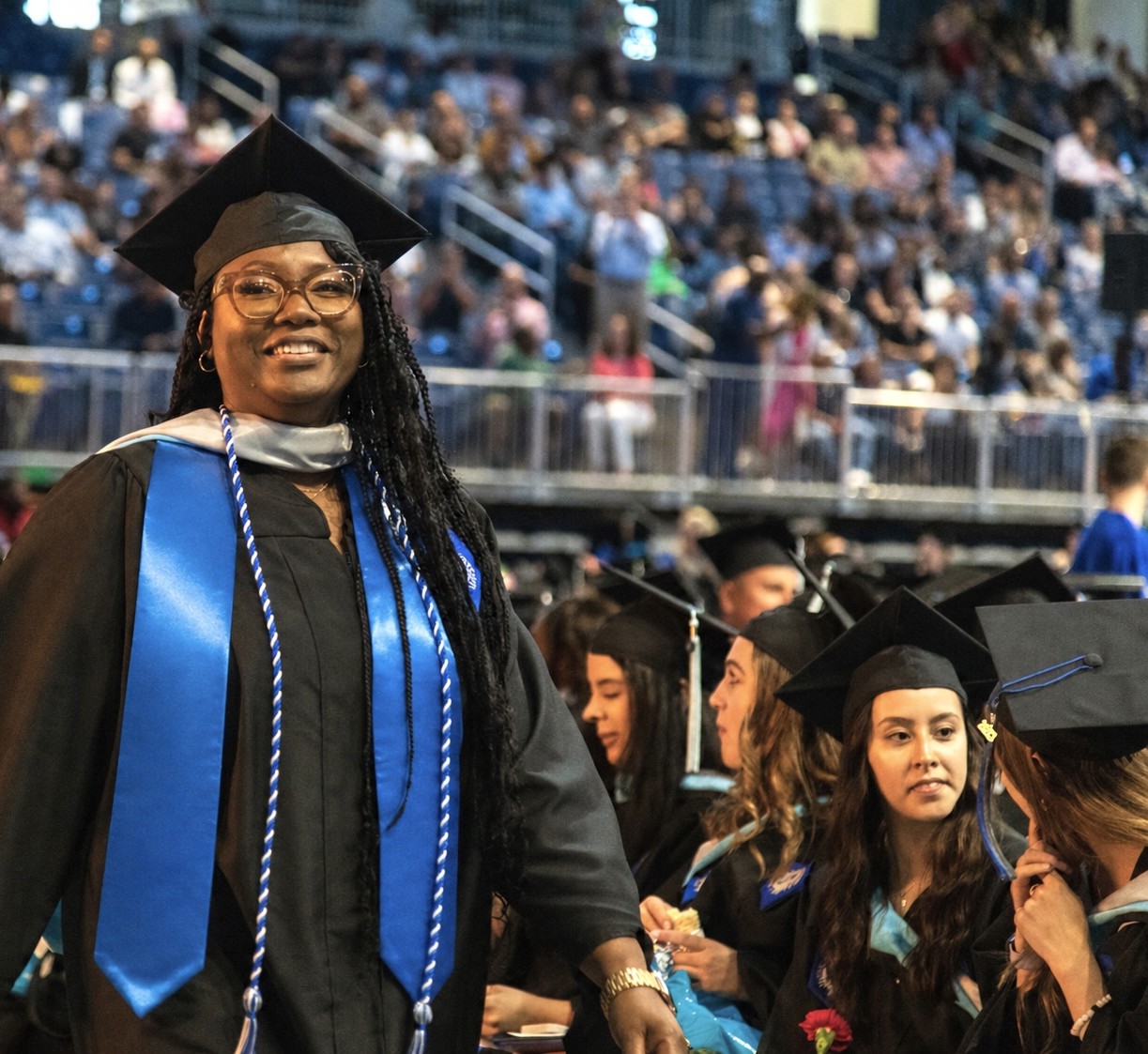 students at a commencement ceremony wearing graduation regalia